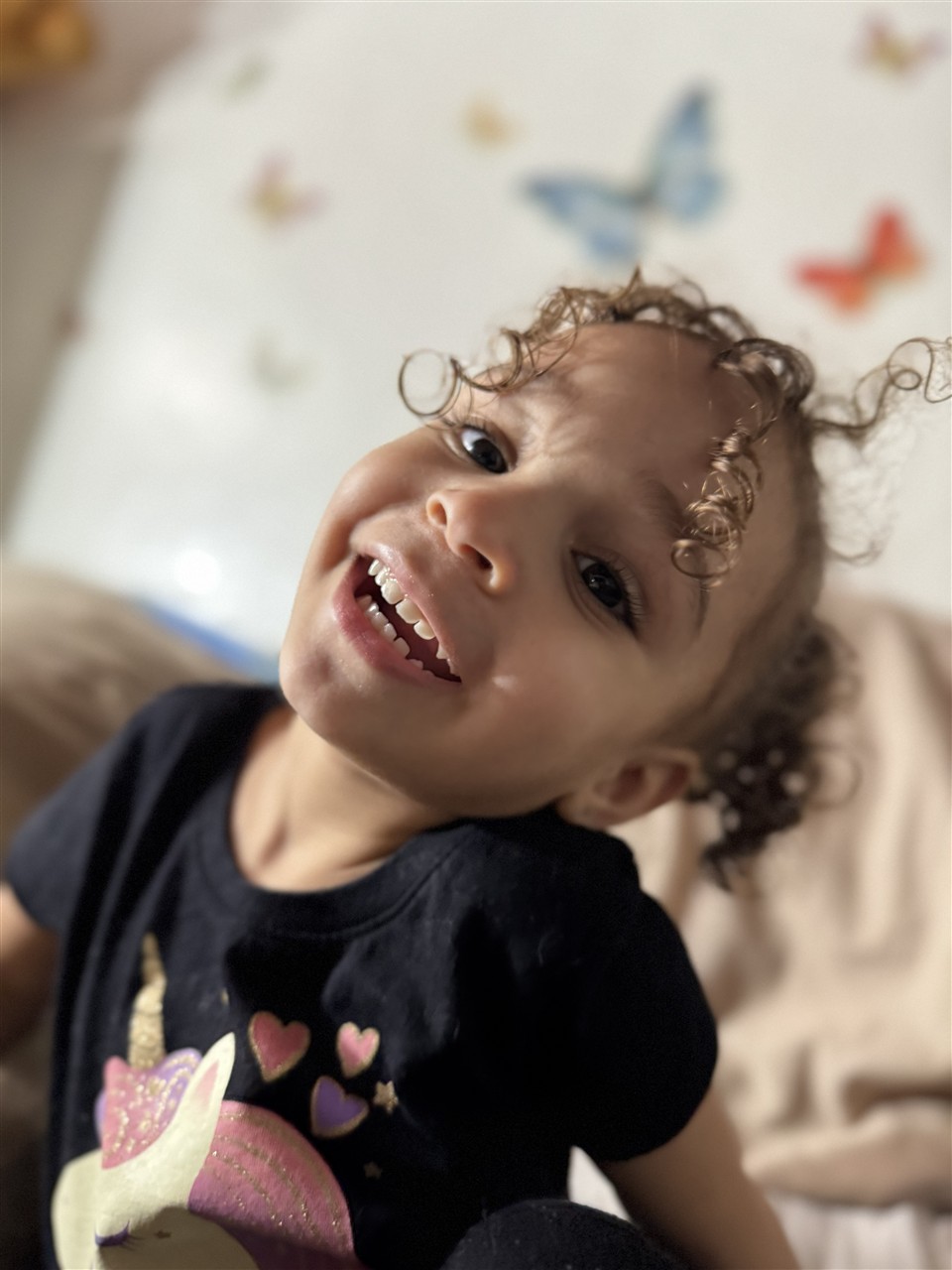 Ruby laughing, with her brown curls framing her face