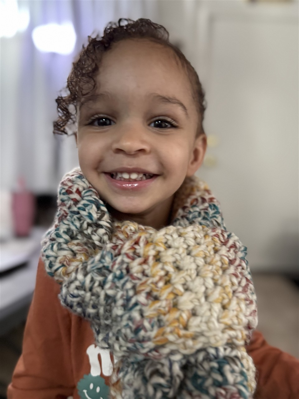 Ruby smiling in a cozy scarf